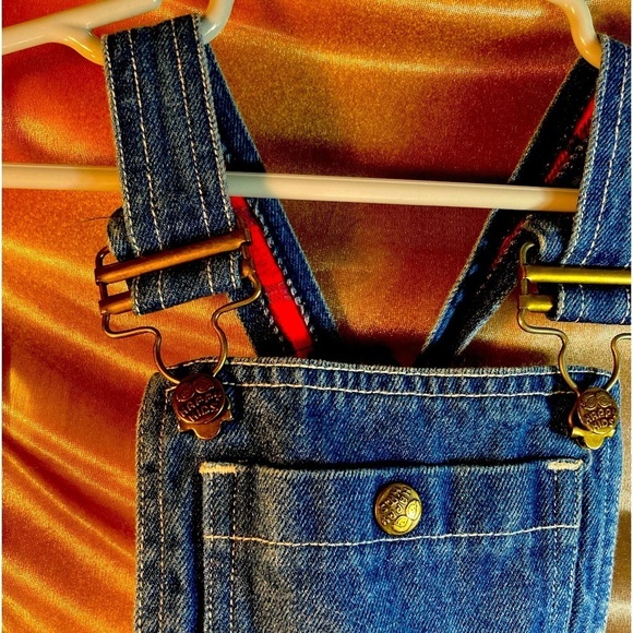 Vintage 80’s denim overalls with red flannel accents. Size 2 happy kids size 2